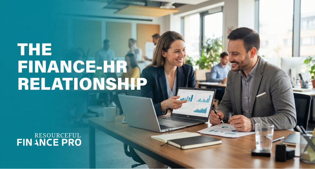 A finance leader and HR partner review charts on a laptop together, illustrating a strong finance-HR working relationship